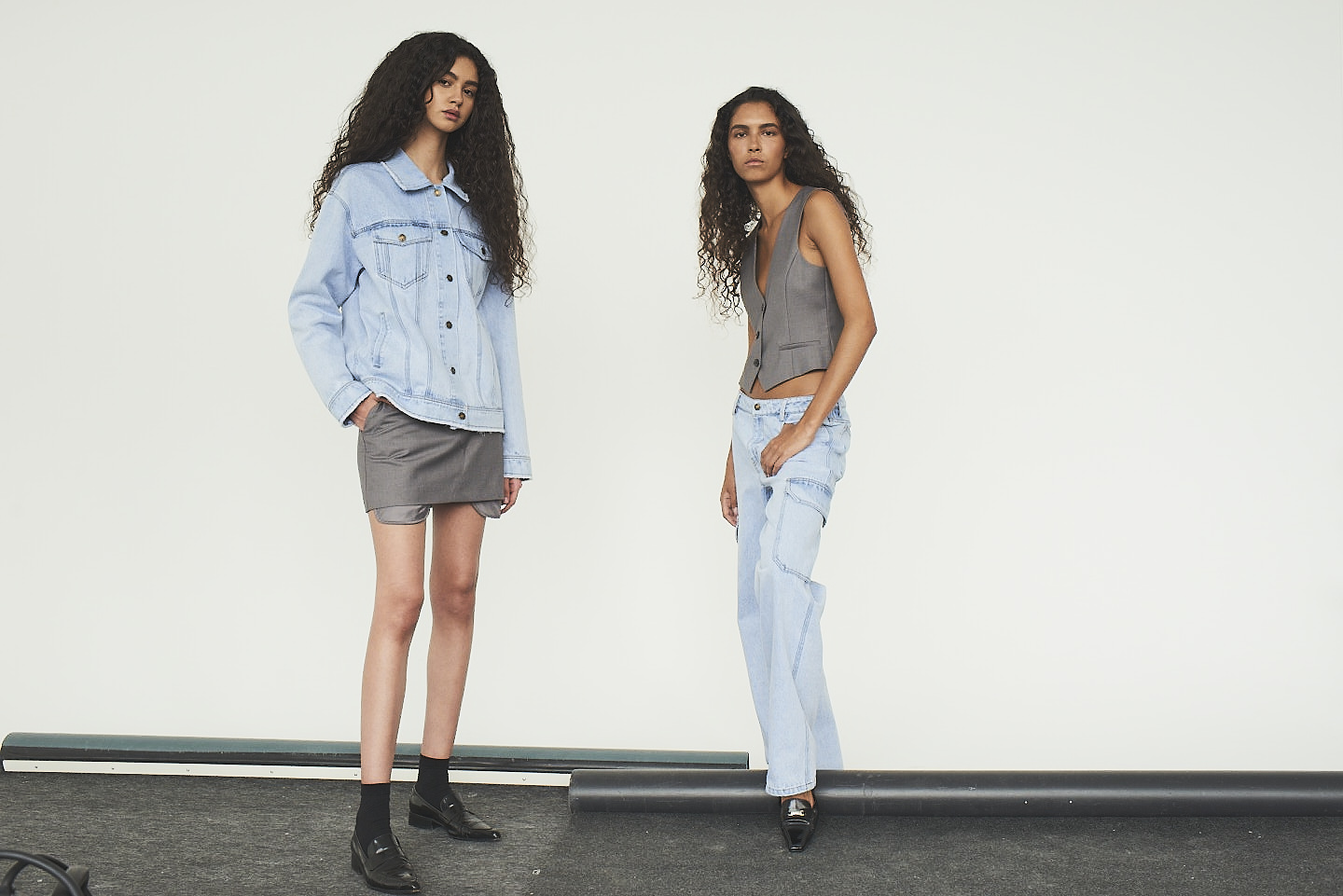 Two girls wearing Designers Remix clothes.