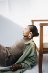 a fancy woman leaning on a chair